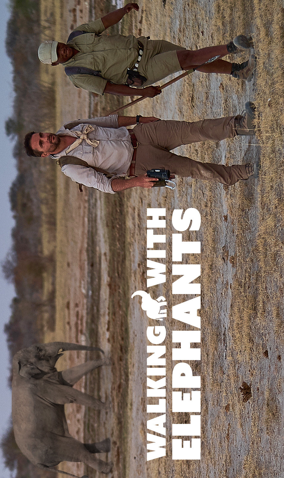 Two people walking in a savannah with an elephant in the background, featuring the text 'Walking with Elephants'.